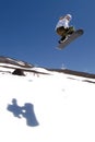 Woman snowboarder jump shadow