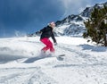 Woman snowboarder in motion in mountains