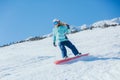 Woman snowboarder in the mountains