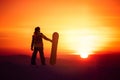 Woman snowboarder silhouette on sunset backdrop Royalty Free Stock Photo