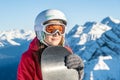 Woman snowboarder standing with snowboard. Closeup portrait