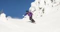 Woman Snowboarding in Alpine Terrain