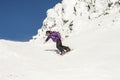 Woman Snowboarding in Alpine Terrain