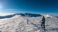 Kor Alps - Woman in snowshoes on the way to majestic summit peak Grosser Speikogel in Kor Alps, Lavanttal Alps