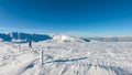 Kor Alps - Woman in snowshoes on the way to majestic summit peak Grosser Speikogel in Kor Alps, Lavanttal Alps