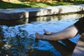 woman soaking feet in hot mineral spring water Royalty Free Stock Photo