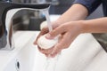 Woman with soap bar washing hands in bathroom, closeup Royalty Free Stock Photo