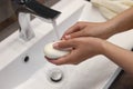 Woman with soap bar washing hands in sink, closeup Royalty Free Stock Photo