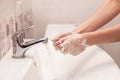 A woman is soaping her hands with soap. Hygiene. Washing hands in the bathroom. Royalty Free Stock Photo