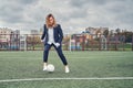 Woman soccer player on the stadium field performs dribbling feint with the ball. concept office manager resting on lunch break Royalty Free Stock Photo