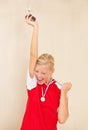 Woman, soccer player and trophy or a winner celebrate on a plain background for football achievement. A young female