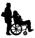 Woman social worker strolling with elder disabled patient man in wheelchair. Royalty Free Stock Photo