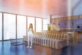 Woman with sofa at kitchen room with furniture and window, lens flare