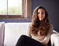 Woman, sofa and portrait at home relax with a calm smile on a break in a living room. Couch, lounge and happy female Royalty Free Stock Photo