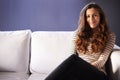 Woman, sofa and portrait in a home relax with smile on break in a living room. Couch, lounge and happy female person Royalty Free Stock Photo