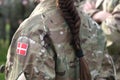 Woman soldier. Woman in army. Flag of Denmark on soldiers arm. Denmark military uniform. Danish troops