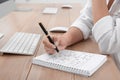 Woman solving sudoku puzzle at table Royalty Free Stock Photo