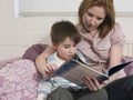 Woman And Son With Picture Book Looking At Each Other Royalty Free Stock Photo