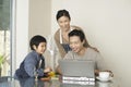 Woman And Son Watching Man Use Laptop Royalty Free Stock Photo