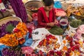 Woman sorting out traditional herbs and spices at Diwali market in Kathmandu, Nepal