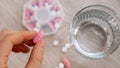 Woman sorting pills Organizer weekly shots Closeup of medical pill box with doses of tablets for daily take medicine