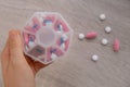 Woman sorting pills Organizer weekly shots Closeup of medical pill box with doses of tablets for daily take medicine