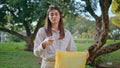 Woman sorting recyclables park showing environmentalism closeup. Conservationist