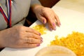 Woman sorts amber blanks in workshop