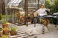 Woman sowing flower seeds at backyard