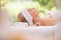 Woman, spa and break for zen, peace and wellness with relaxation and calm. Lady, towel and massage table at resort Royalty Free Stock Photo