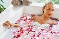 Woman Spa Flower Bath. Aromatherapy. Relaxing Rose Bathtub. Beauty Royalty Free Stock Photo