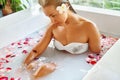 Woman Spa Flower Bath. Aromatherapy. Relaxing Rose Bathtub. Beauty Royalty Free Stock Photo