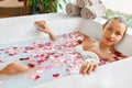 Woman Spa Flower Bath. Aromatherapy. Relaxing Rose Bathtub. Beauty Royalty Free Stock Photo