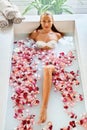 Woman Spa Flower Bath. Aromatherapy. Relaxing Rose Bathtub. Beauty Royalty Free Stock Photo