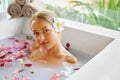 Woman Spa Flower Bath. Aromatherapy. Relaxing Rose Bathtub. Royalty Free Stock Photo