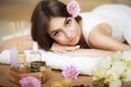 Woman at the spa. Healthy lifestyle and relaxation concept. A beautiful young woman on a massage table. Aroma oil and butter. Spa Royalty Free Stock Photo