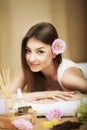 Woman at the spa. Healthy lifestyle and relaxation concept. A beautiful young woman on a massage table. Aroma oil and butter. Spa Royalty Free Stock Photo