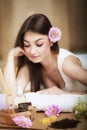 Woman at the spa. Healthy lifestyle and relaxation concept. A beautiful young woman on a massage table. Aroma oil and butter. Spa Royalty Free Stock Photo