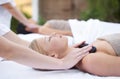 Woman at spa, hot stone massage and hands of masseuse, healing holistic treatment with zen at wellness resort. Rocks on Royalty Free Stock Photo