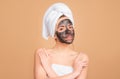 Woman spa mask half-face beauty concept. Mud facial mask, face clay mask spa. Beautiful woman with cosmetic mud facial Royalty Free Stock Photo