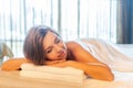 Woman in spa salon relaxing with closed eyes, waiting massage