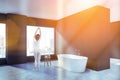 Woman in spacious gray bathroom corner Royalty Free Stock Photo