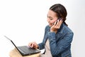 Woman speaking mobile phone and using computer Royalty Free Stock Photo