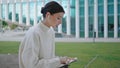 Woman speaking webinar outdoors at laptop. Businesswoman talking video meeting. Royalty Free Stock Photo