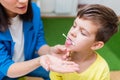 A woman speech therapist deals with the child and teaches him the correct pronunciation and competent speech