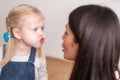 Woman speech therapist teaches a girl the correct pronunciation and literate speech