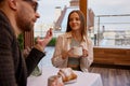 Woman spending time with man during speed dating in cozy coffeeshop