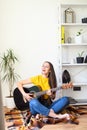 Woman spends leisure playing guitar Royalty Free Stock Photo