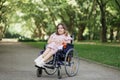 Woman with spinal muscular atrophy smiling at park