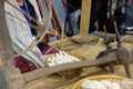 woman spinning cotton into thread with traditional wheel Royalty Free Stock Photo